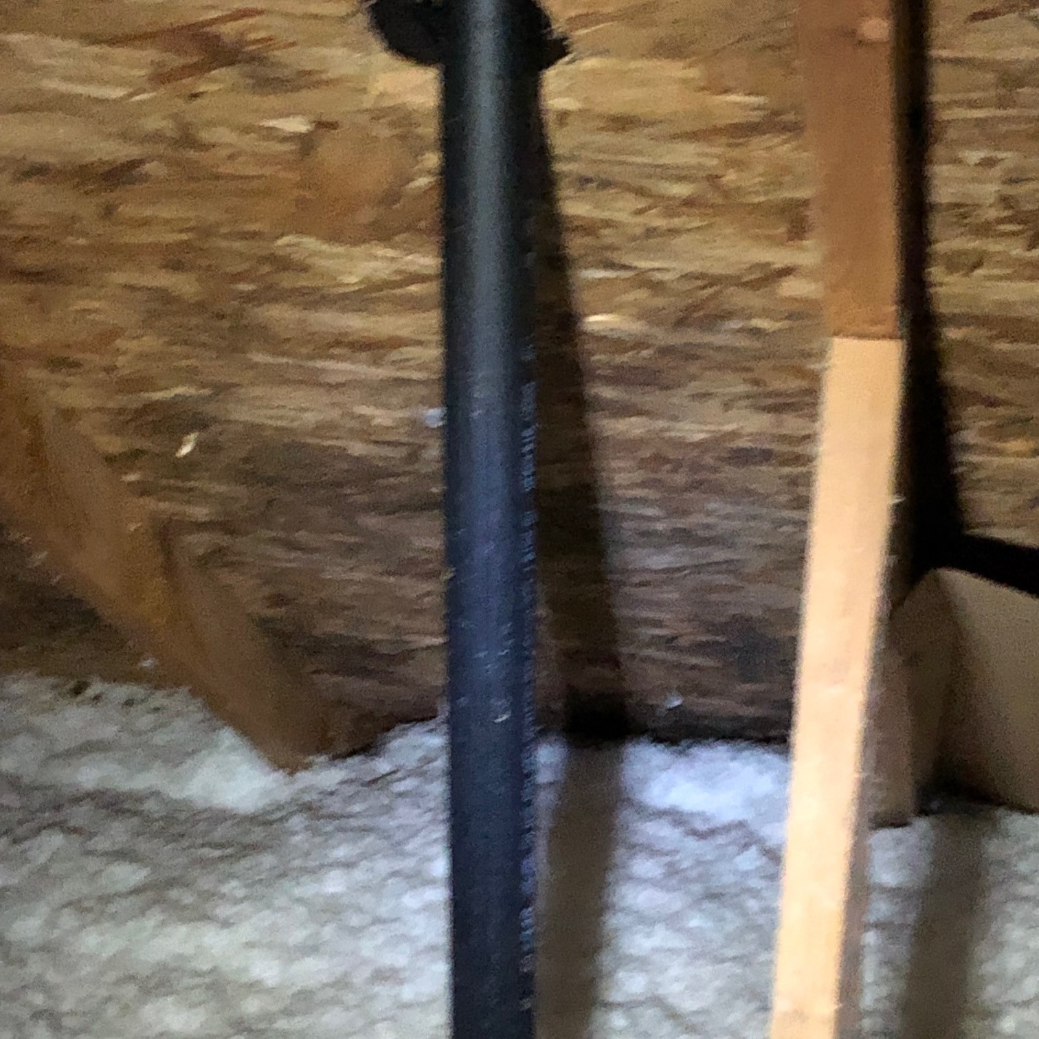 Water staining on roof decking in an attic showing the true path of a roof leak