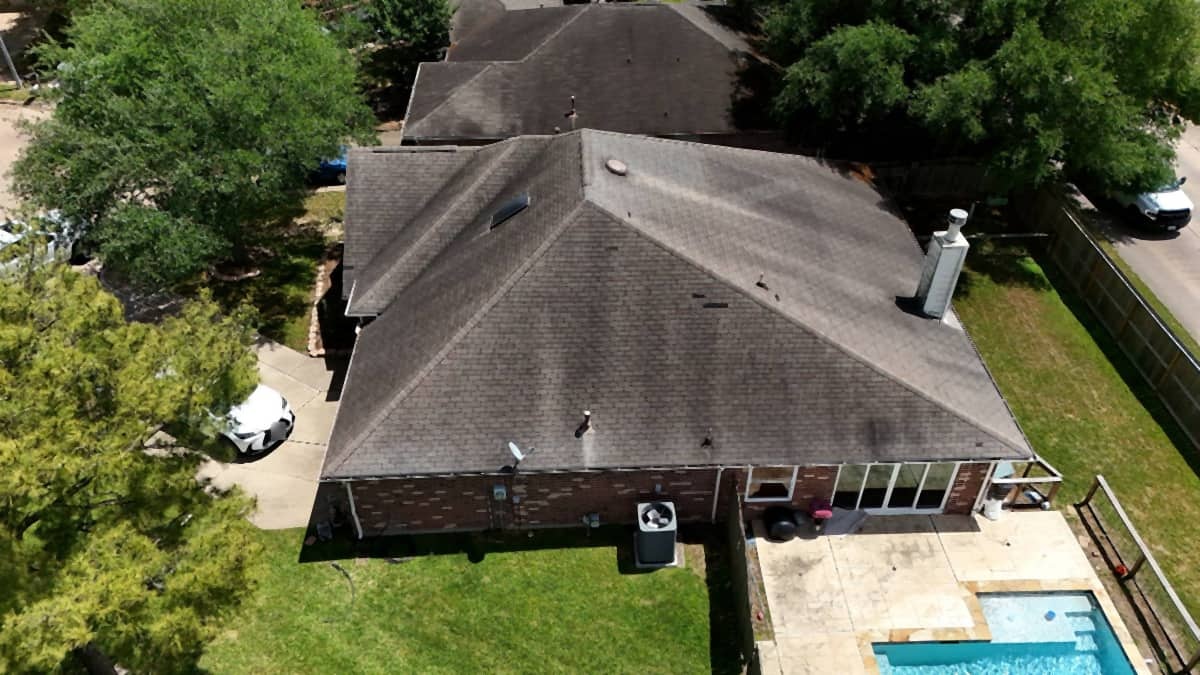 Before: weathered three-tab shingle roof with hail damage on an Austin home