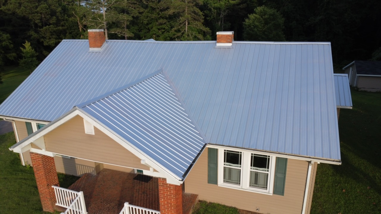 Standing seam metal roof in dark gray installed by Tex Roof on a modern Austin home