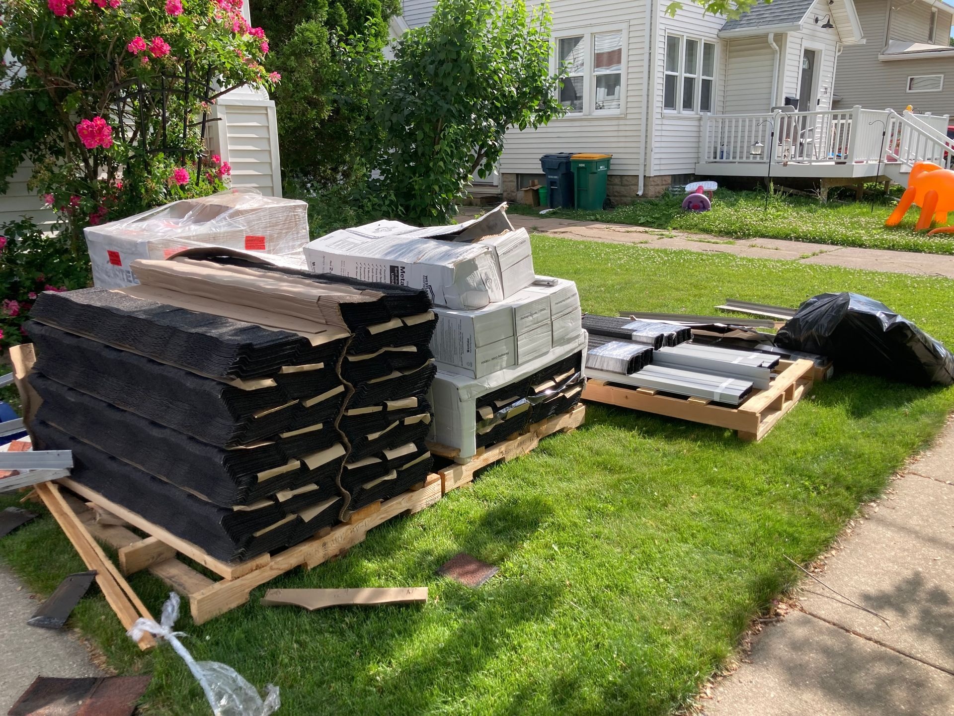 Tex Roof crew members on a job site in Austin with materials staged for installation