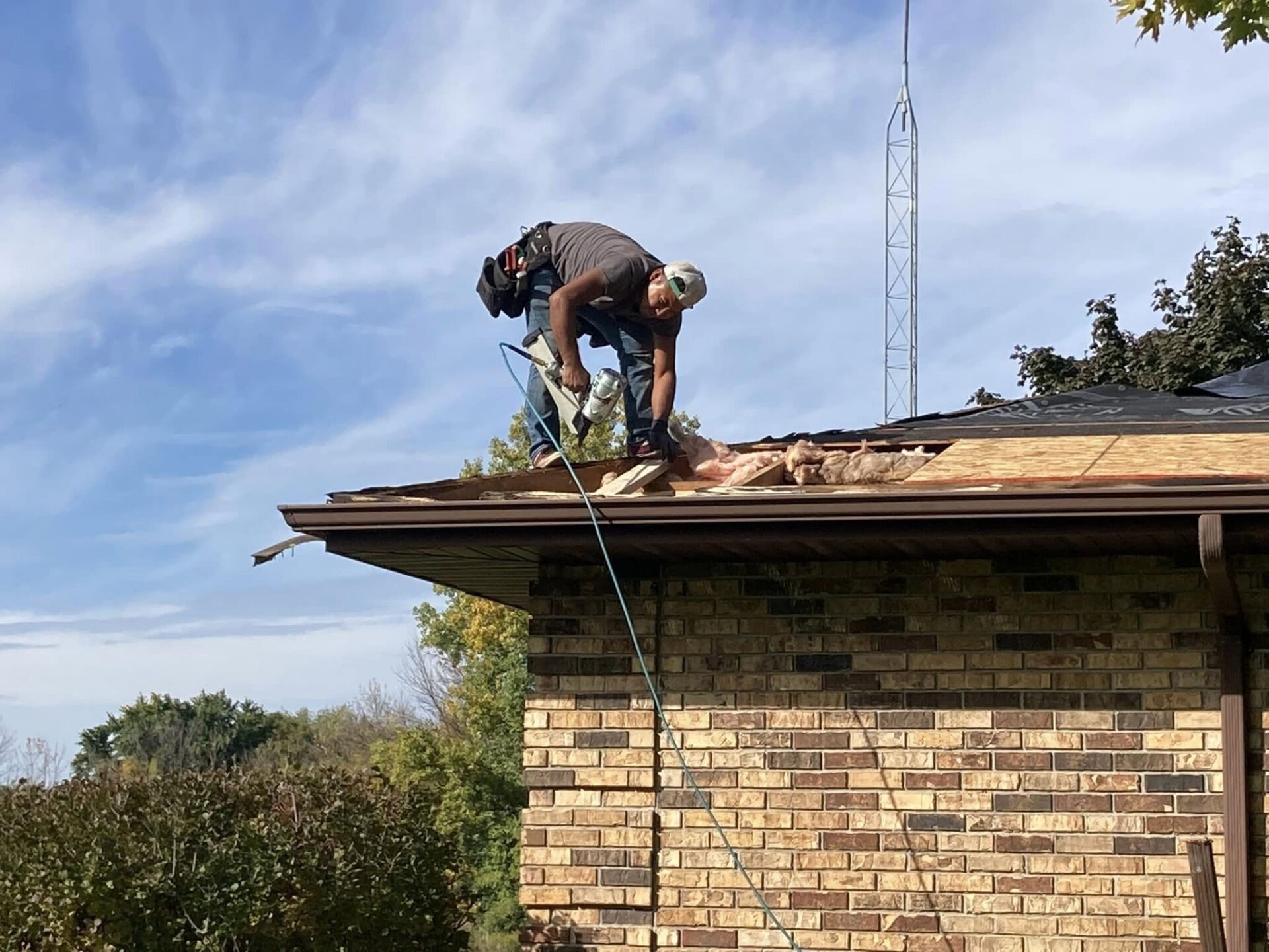 Tex Roof installer nailing architectural shingles with proper six-nail pattern